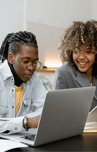 Two people collaborating on a laptop