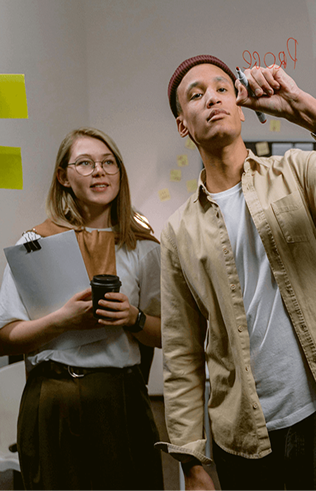 Two people smiling, one holding a cup